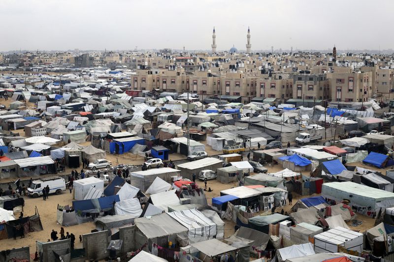 FILE - A tent camp housing Palestinians displaced by the Israeli offensive is seen in Rafah, Gaza Strip, on Feb. 27, 2024. The tent camps stretch for more than 16 kilometers (10 miles) along Gaza’s coast, filling the beach and sprawling into empty lots, fields and town streets. (AP Photo/Hatem Ali, file)