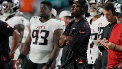 Atlanta Falcons head coach Raheem Morris watches the game from the sidelines during the first half of a pre season NFL football game against the Miami Dolphins, Friday, Aug. 9, 2024, in Miami Gardens, Fla. (AP Photo/Lynne Sladky)