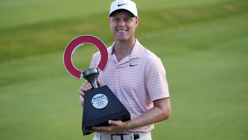 Cam Davis celebrates winning the Rocket Mortgage Classic golf tournament at Detroit Country Club, Sunday, June 30, 2024, in Detroit. (AP Photo/Paul Sancya)