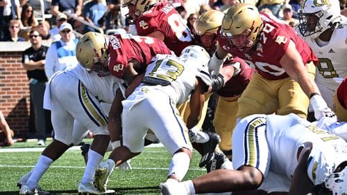 Boston College running back Kye Robichaux (5) pushes against Georgia Tech defensive back Jaylon King (left) and linebacker Paul Moala (13) for a touchdown during the second half of an NCAA college football game at Bobby Dodd Stadium, Saturday, October 21, 2023, in Atlanta. B(Hyosub Shin / Hyosub.Shin@ajc.com)