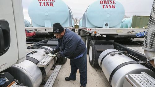 Jason Robinson logs data as he prepared the brine trucks at the Georgia Department of Transportation Maintenance Activities in Forest Park on Thursday. JOHN SPINK/JSPINK@AJC.COM