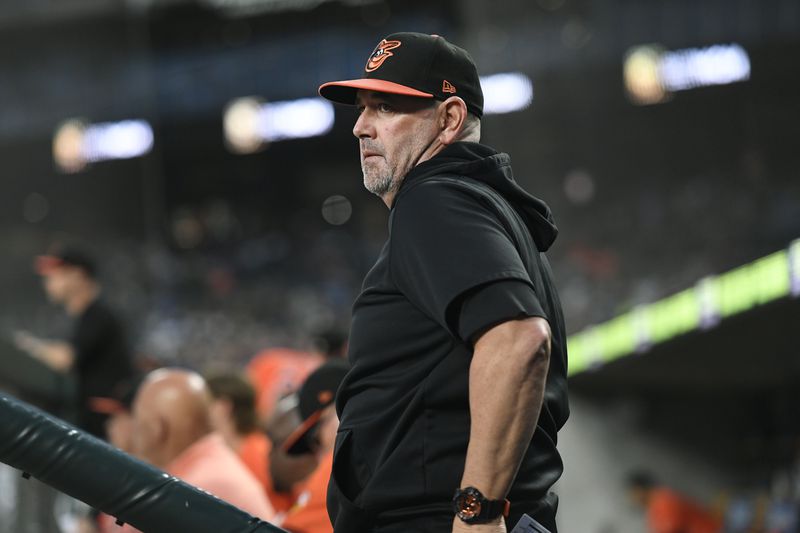 Baltimore Orioles manager Brandon Hyde watches from the dugout in the fifth inning of a baseball game against the Detroit Tigers, Friday, Sept. 13, 2024, in Detroit. (AP Photo/Jose Juarez)