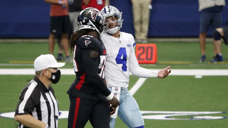 Cowboys quarterback Dak Prescott (4) exchanges words with Falcons defensive end Takk McKinley (98) between Sunday, Sept. 20, 2020, in Arlington, Texas. (Michael Ainsworth/AP)