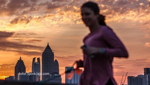 Lauren Adams jogs down  17th Street as the sun rises on Tuesday.