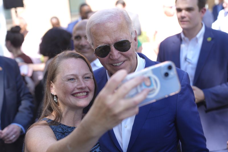 President Joe Biden, right, takes a photo with a supporter at a campaign rally in Harrisburg, Pa., on Sunday, July 7, 2024. (AP Photo/Manuel Balce Ceneta)