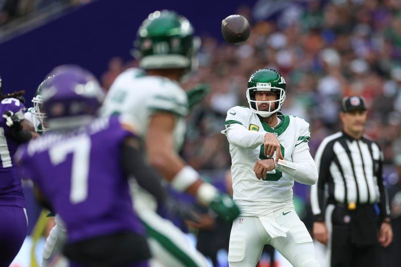 New York Jets quarterback Aaron Rodgers throws during the first half of an NFL football game against the Minnesota Vikings, Sunday, Oct. 6, 2024, at the Tottenham Hotspur stadium in London. (AP Photo/Ian Walton)