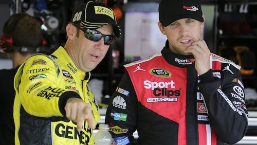Matt Kenseth, left, points out something to Denny Hamlin before a NASCAR Sprint Cup practice session at Darlington Raceway in Darlington, S.C., Friday, Sept. 4, 2015. (AP Photo/Terry Renna)