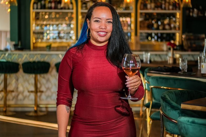 Jordan Lynn Traylor, partner at Marietta Proper, poses with a glass of wine inside her restaurant in Smyrna. Courtesy of Thomas Swofford