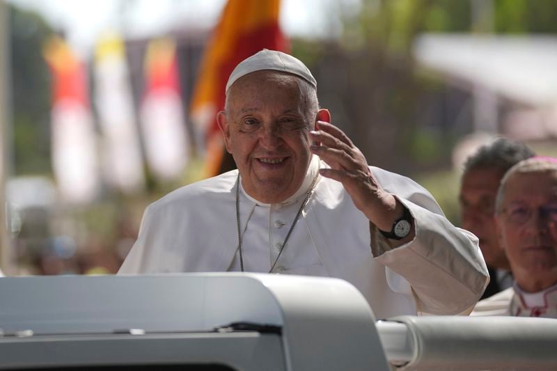 Pope Francis gestures from the car, in Dili, East Timor, Monday, Sept. 9, 2024. (AP Photo/Dita Alangkara)