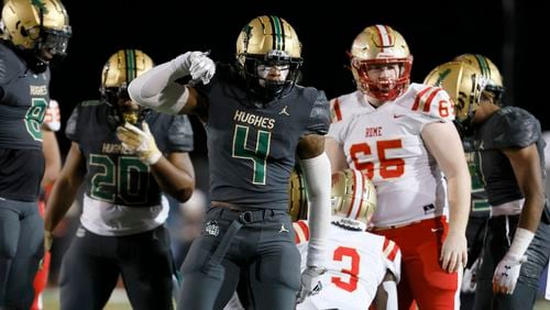 Langston Hughes linebacker Gannon Weathersby (4) reacts after making a tackle on Rome wide receiver Dekaylon Daniel (3) in the first of their Class 6A semi-final at Lakewood Stadium, Friday, December 2, 2022, in Atlanta. Jason Getz / Jason.Getz@ajc.com)
