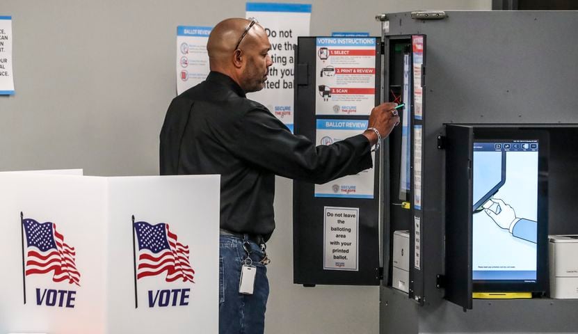 October 17, 2022 Atlanta: Todd Presley casts his ballot. Several dozen voters were there in the first hour of early voting at the Buckhead Library located at 269 Buckhead Avenue NE in Atlanta on Monday, Oct. 17, 2022. (John Spink / John.Spink@ajc.com) 

