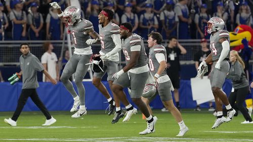 Members of UNLV run onto the field after a 23-20 win over Kansas during an NCAA college football game, Friday, Sept. 13, 2024, at Children's Mercy Park in Kansas City, Kan. (AP Photo/Ed Zurga)