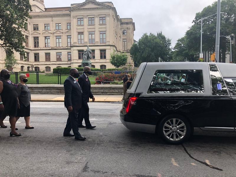 Members of the Georgia Legislative Black Caucus walk behind Rep. John Lewis’ hearse as it leaves the state Capitol. Led by state Rep. Calvin Smyre and state Sen. Ed Harbison, both Columbus Democrats who are the longest serving legislators in their respective chambers, members of the Georgia Legislative Black Caucus escorted the hearse carrying John Lewis off of Capitol grounds. (AJC Staff)