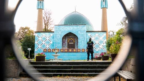 A police officer stands outside the Islamic Center Hamburg with the Imam Ali Mosque during a raid Wednesday, July 24, 2024, Hamburg, Germany. (Daniel Bockwoldt/dpa via AP)