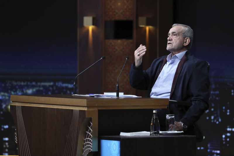 In this picture made available by Iranian state-run TV, IRIB, reformist candidate for the presidential election Masoud Pezeshkian speaks in his debate with the hard-line candidate Saeed Jalili at the TV studio in Tehran, Iran, Monday, July 1, 2024. (Morteza Fakhri Nezhad/IRIB via AP)