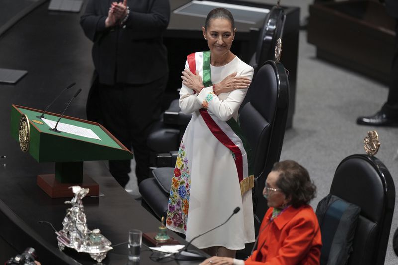 President Claudia Sheinbaum smiles after being sworn in as Mexico's president at Congress in Mexico City, Tuesday, Oct. 1, 2024. (AP Photo/Fernando Llano)