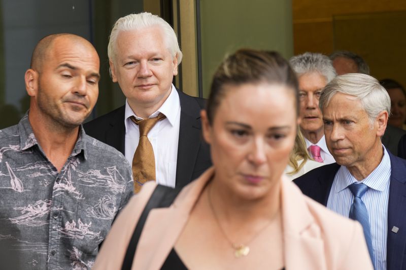 WikiLeaks founder Julian Assange, second left, leaves the federal court in Saipan, Mariana Islands, Wednesday, June 26 2024. (AP Photo/Eugene Hoshiko)