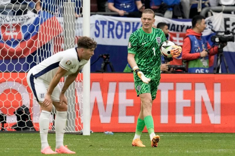 England's goalkeeper Jordan Pickford and John Stones, left, react after Slovakia's Ivan Schranz scored the opening goal during a round of sixteen match between England and Slovakia at the Euro 2024 soccer tournament in Gelsenkirchen, Germany, Sunday, June 30, 2024. (AP Photo/Thanassis Stavrakis)