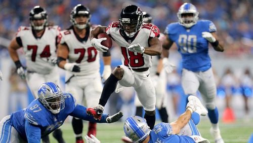 Falcons wide receiver Taylor Gabriel hurdles Armonty Bryant Lions and Nick Bellore (#43) during the first quarter at Ford Field on September 24 in Detroit, Michigan.