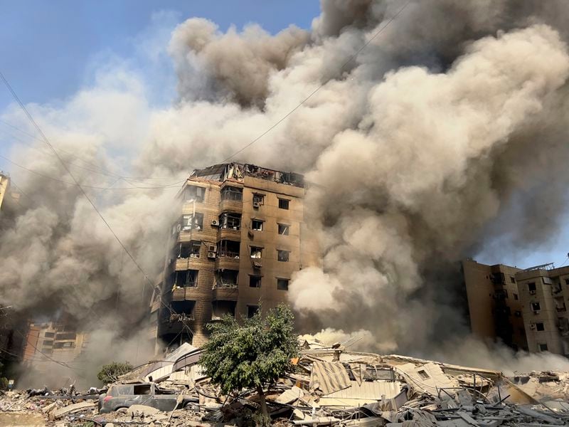 Smoke rises as a building collapses in Beirut's southern suburbs, Saturday, Sept. 28, 2024. (AP Photo/Hussein Malla)