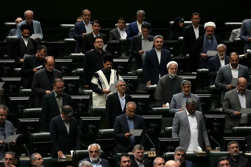 Iranian lawmakers take an oath during the opening ceremony of the new parliament term, in Tehran, Iran, Monday, May 27, 2024. Monday marked the first day for Iran's newly elected parliament, following a March election that saw the country's lowest turnout since its 1979 Islamic Revolution. Of those elected to the 290-seat body, hard-liners hold over 230 seats, according to an Associated Press survey. (AP Photo/Vahid Salemi)