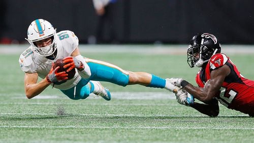 ATLANTA, GA - AUGUST 30:  Drew Morgan #81 of the Miami Dolphins is tackled by Tyson Graham #32 of the Atlanta Falcons at Mercedes-Benz Stadium on August 30, 2018 in Atlanta, Georgia.  (Photo by Kevin C. Cox/Getty Images)