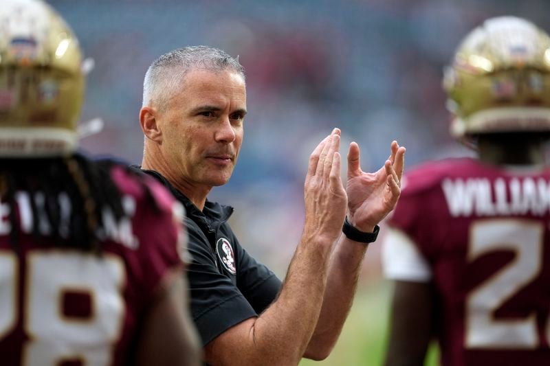 FILE - Florida State head coach Mike Norvell claps as his players warm up for the Orange Bowl NCAA college football game against Georgia, Saturday, Dec. 30, 2023, in Miami Gardens, Fla. (AP Photo/Rebecca Blackwell, File)