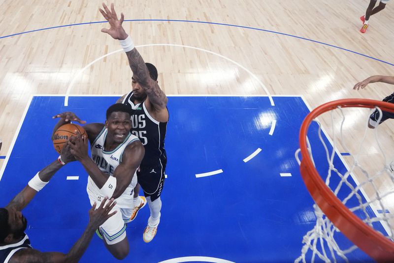 Minnesota Timberwolves guard Anthony Edwards goes up for a shot as Dallas Mavericks forward P.J. Washington, right, defends during the second half of Game 1 of the NBA basketball Western Conference finals, Wednesday, May 22, 2024, in Minneapolis. (AP Photo/Abbie Parr)