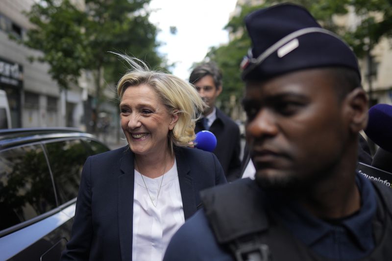 Far-right leader Marine Le Pen arrives at the National Rally party headquarters, Thursday, July 4, 2024 in Paris. The National Rally secured the most votes in the first round of the early legislative elections on June 30 but not enough to claim an overall victory that would allow the formation of France's first far-right government since World War II. (AP Photo/Thibault Camus)