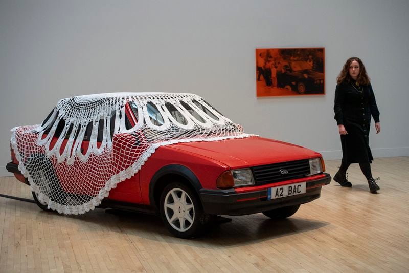 A woman passes by an artwork by Jasleen Kaur during the Turner Prize 2024 press preview at Tate Britain in London, part of the 40th anniversary exhibition featuring four shortlisted artists, Tuesday, Sept. 24, 2024. (AP Photo/Thomas Krych)