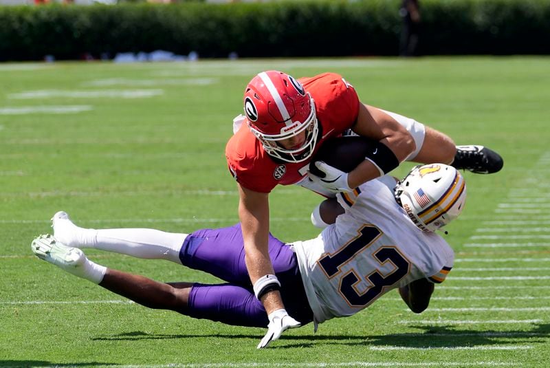 Georgia tight end Lawson Luckie (7) is brought down by Tennessee Tech defensive back Caldra Williford (13) after a catch during the first half of an NCAA college football game Saturday, Sept. 7, 2024, in Athens, Ga. (AP Photo/John Bazemore)