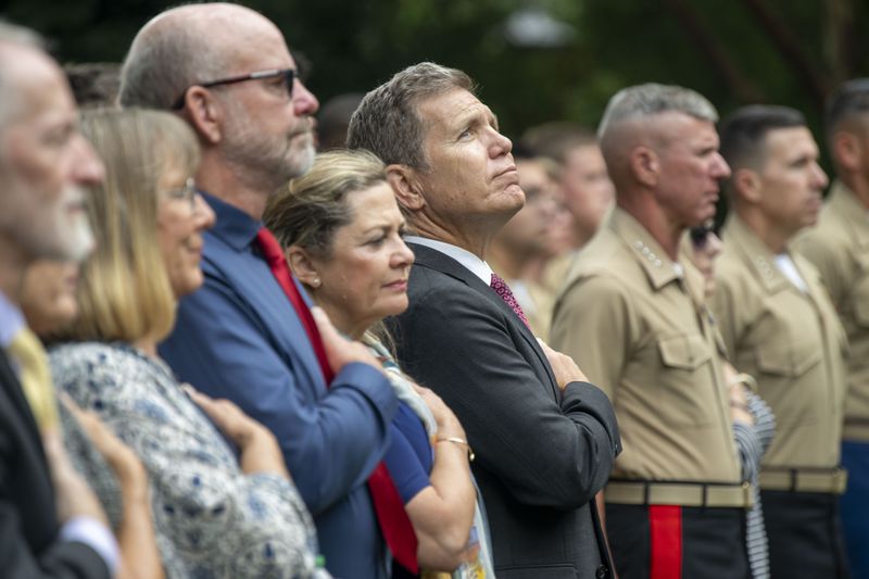 Bart Collart, the father of Cpl. Spencer Collart, looks up during the playing of the National Anthem during a Navy and Marine Corps medal awarding ceremony for his son on Monday, Sept. 16, 2024 in Washington. (AP Photo/Kevin Wolf)