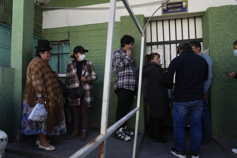 Satusa Apaza, left, and others stand outside the jail to leave food for their detained relatives being held for their alleged involvement in what President Luis Arce called a coup attempt in La Paz, Bolivia, Friday, June 28, 2024. (AP Photo/Juan Karita)