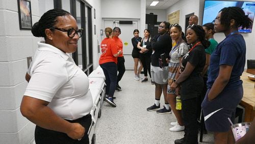 City of Decatur Fire Chief Toni Washington (left) answers a question from the participants as Annette Haygood (background), DeKalb County post coordinator, leads a tour during a “Females in the Fire Service” event. (Hyosub Shin / AJC)