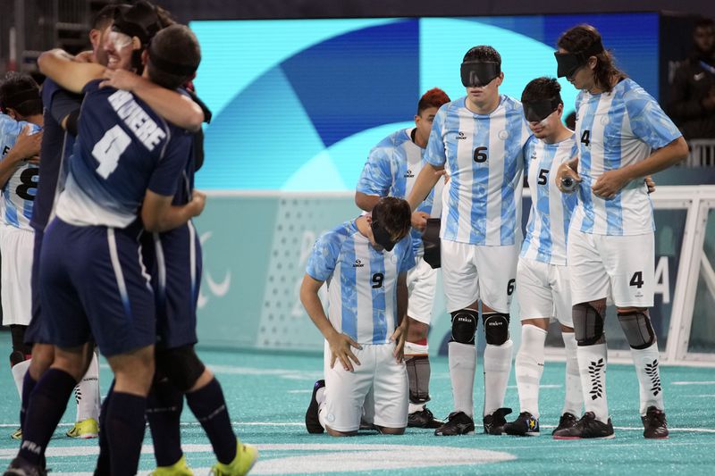 Argentina players look dejected after losing the blind football gold medal match at the 2024 Paralympics, Saturday, Sept. 7, 2024, in Paris, France. (AP Photo/Christophe Ena)