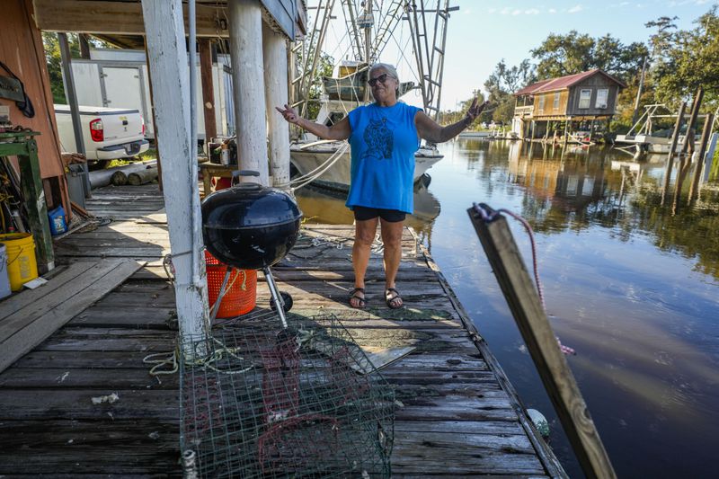 Debra Matherne describes her experience as she rode out Hurricane Francine the previous night, along Bayou Pointe-au-Chien, La., Thursday, Sept. 12, 2024. (AP Photo/Gerald Herbert)