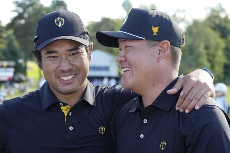 International team member Hideki Matsuyama, left, of Japan, and partner Sungjae Im, right, of South Korea, celebrate after winning a second-round foursome match at the Presidents Cup golf tournament at Royal Montreal Golf Club, Friday, Sept. 27, 2024 in Montreal. (Frank Gunn/The Canadian Press via AP)