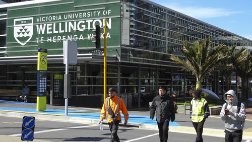 People walk past the name of Victoria University of Wellington, written in English and Maori languages as New Zealand celebrates its annual Maori language week in Wellington, New Zealand, Wednesday, Sept. 18, 2024. (AP Photo/Charlotte GrahamMcLay)