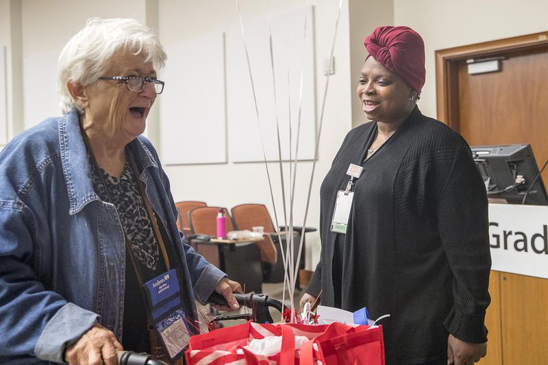 04/12/2019  -- Atlanta, Georgia -- Grady Chronic Care Clinic Community health worker Bryna Robinson (right), speaks with Nancy Carter (left), a care clinic attendee, following a graduation celebration at Grady Memorial Hospital in Atlanta, Friday, April 12, 2019. The Chronic Care Clinic hosted a celebration graduation for people who had fallen out of the health system, except for going to the ER for emergencies. These patients are signed up for the Chronic Care Clinic and "surrounded" with resources including a community health worker who works with them to educate them on using resources properly, such as taking medications regularly, going to a primary care clinic for non-emergencies, and keeping up with problems before they become emergencies. (ALYSSA POINTER/ALYSSA.POINTER@AJC.COM)