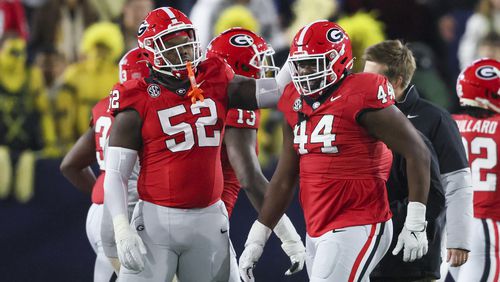 Georgia defensive lineman Christen Miller (52) and Georgia defensive lineman Jordan Hall (44) celebrate a play against Georgia Tech at Bobby Dodd Stadium, Saturday, November 25, 2023, in Atlanta. Georgia won 31-23. (Jason Getz / Jason.Getz@ajc.com)