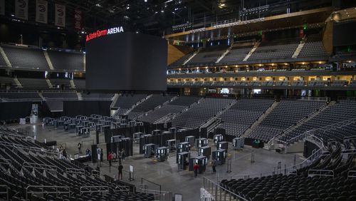 Fulton County department of registration and elections employees work on securing each voting machine at State Farm Arena in Atlanta, Wednesday, October 7, 2020. (Alyssa Pointer / Alyssa.Pointer@ajc.com)