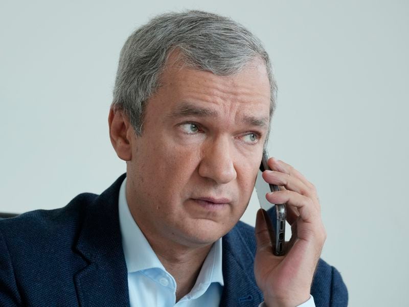 FILE - Belarusian dissident Pavel Latushka, a prominent opposition figure in exile, talks on the phone in Warsaw, Poland, on Aug. 2, 2021. (AP Photo/Czarek Sokolowski, File)