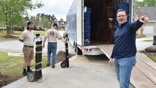 Chris New (right), owner of Barnes Van Lines, supervises workers Joe Nowak (left) and Anson Strickland while moving a family in Villa Rica on Thursday, April 15, 2021. (Hyosub Shin / Hyosub.Shin@ajc.com)