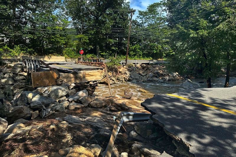 A bridge washed out on Seth Den Road in Oxford, Conn. after torrential rains turned streets into raging rivers in parts of Connecticut and New York's Long Island, trapping people in cars and a restaurant, covering vehicles in mud, and sweeping two women to their deaths, authorities said, Monday, Aug 19, 2024. (AP Photo Dave Collins)