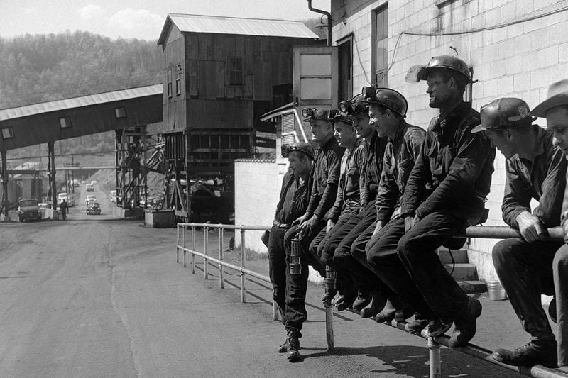 FILE - Miners at the Slabfork Coal company in West Virginia wait for ride home after work, May 6, 1960. (AP Photo, File)