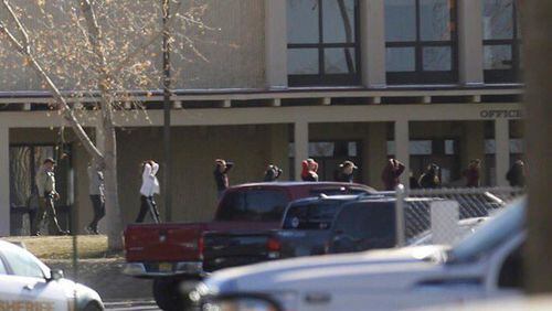 Students are led out of Aztec High School after a shooting Thursday, Dec. 7, 2017, in Aztec, N.M. The school is in the Four Corners region and is near the Navajo Nation. (Jon Austria /The Daily Times via AP)