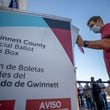 A voter places his ballot inside a drop box on Oct. 13, 2020, the second day of early voting, at the Gwinnett County Voter Registration and Elections building in Lawrenceville. (Alyssa Pointer/Atlanta Journal-Constitution)