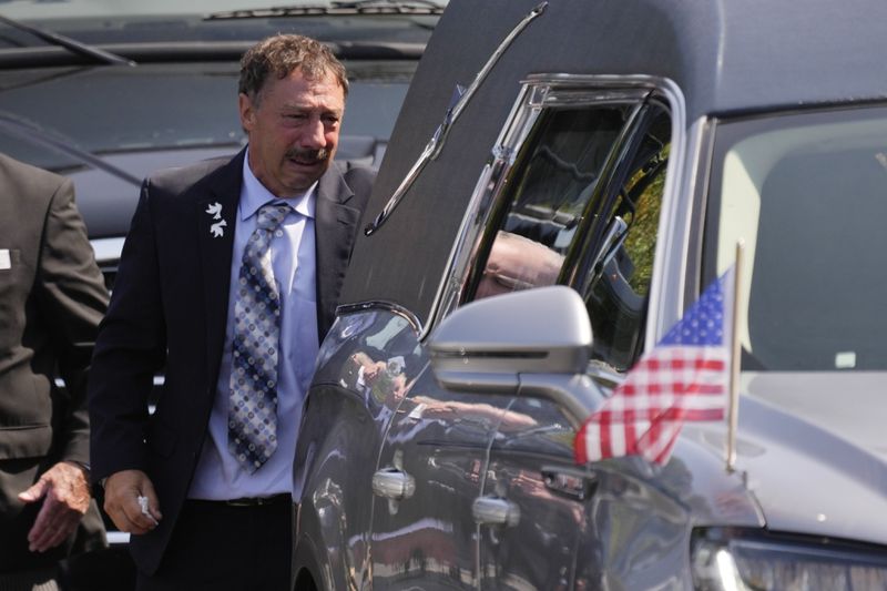 Guy Gaudreau looks into a hearse containing the remains of his son Columbus Blue Jackets hockey player John Gaudreau after his and his brother's Matthew Gaudreau funeral at St. Mary Magdalen Catholic Church in Media, Pa., Monday, Sept. 9, 2024. (AP Photo/Matt Rourke)