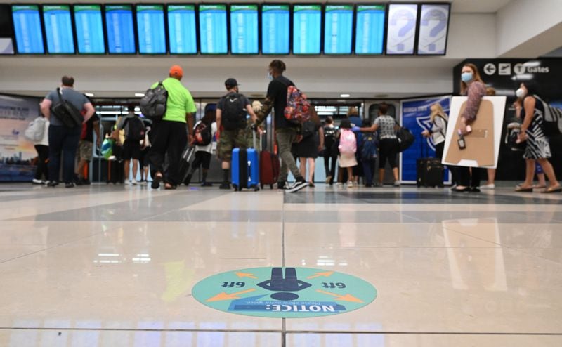 July 22, 2020 Atlanta - Social distancing signs are  displayed as travelers wait for a train on Concourse A at Hartsfield-Jackson International Airport on Wednesday, July 22, 2020. (Hyosub Shin / Hyosub.Shin@ajc.com)