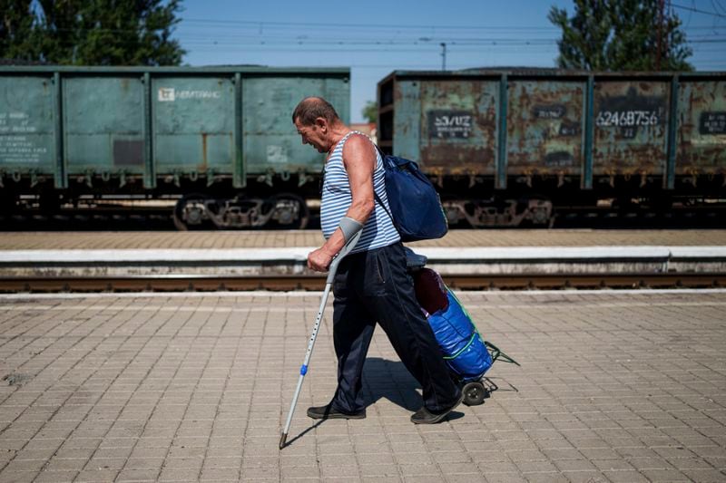 A man walks on a platform during evacuation on the train station in Pokrovsk, Donetsk region, Ukraine, Monday, August 19, 2024. Due to the advance of Russian troops, the war affects more and more new settlements to the west of the Donetsk region. Intensive shelling forced people to leave homes. (AP Photo/Evgeniy Maloletka)